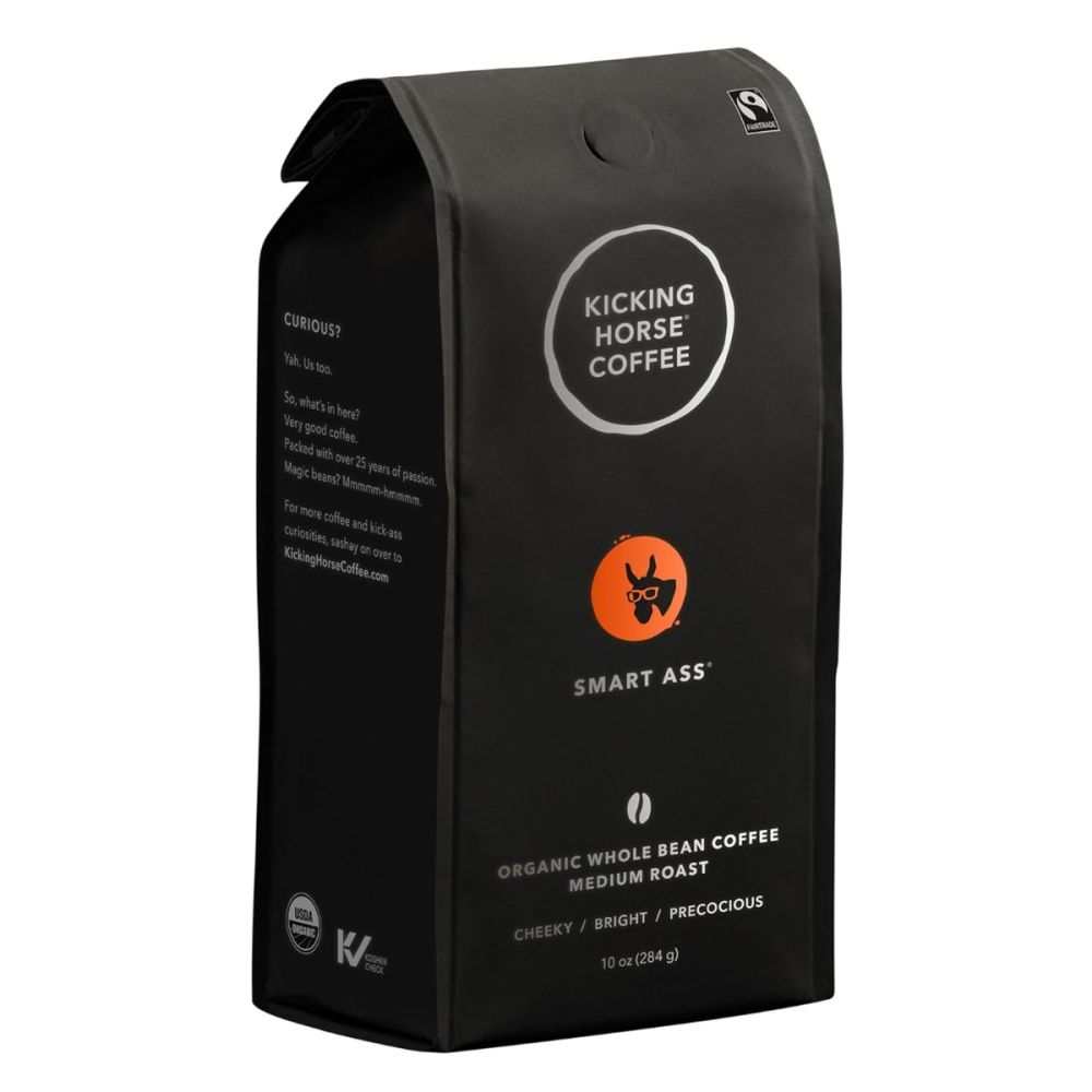 KICKING HORSE Organic Smart Ass Medium Roast whole bean coffee with a half-full cup of bright chocolaty coffee