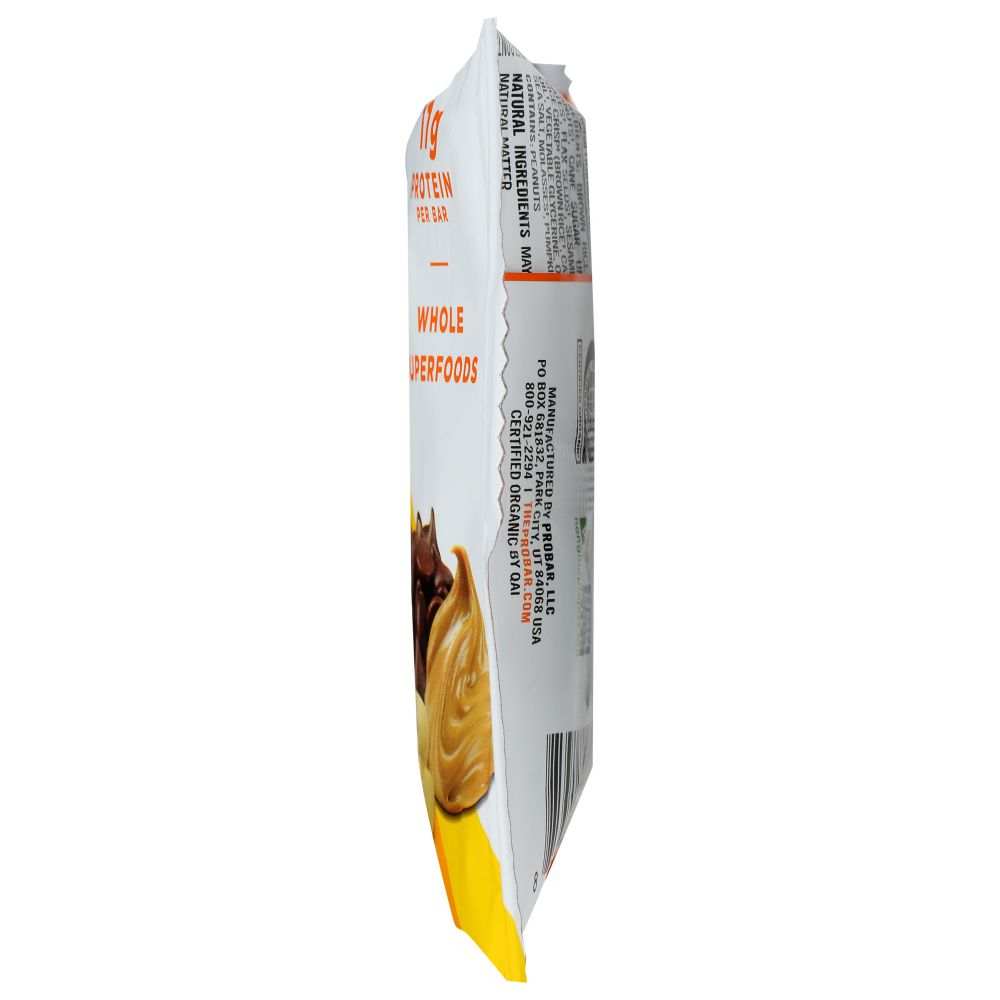 Side view of a protein bar wrapper featuring nut and chocolate visuals, labeled whole superfoods