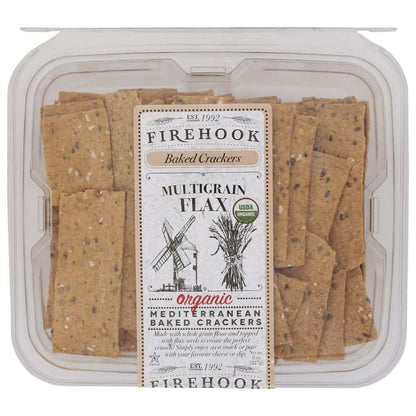 FIREHOOK multigrain flax baked cracker with cheese on a wooden board, crunchy healthy snack