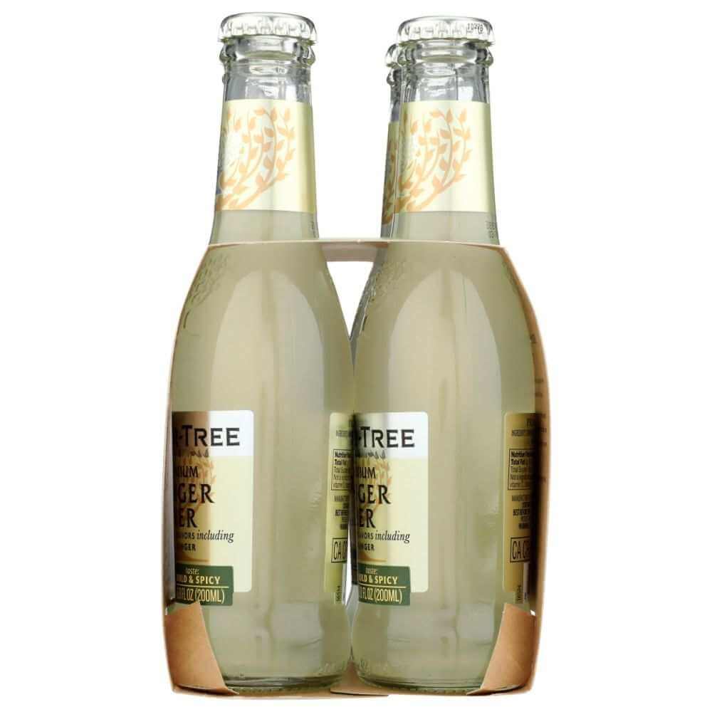 Four-pack of clear glass ginger beer bottles with gold labels in cardboard carrier