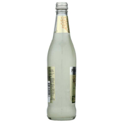 Clear glass bottle with pale liquid and gold label, premium beverage product.