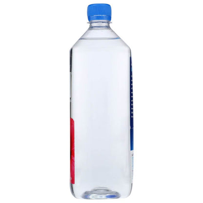 Plastic bottle of clear water with blue cap, partial floral label, isolated on white